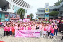 一眾嘉賓及參加者作出粉紅絲帶手勢，藉此傳揚關注乳房健康的訊息。 The guests and participants crossed their fingers to mimic the pink ribbon sign, a symbol held internationally to represent breast cancer awareness.